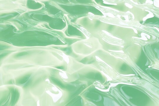 Translucent green gel texture with flowing waves and light reflections.