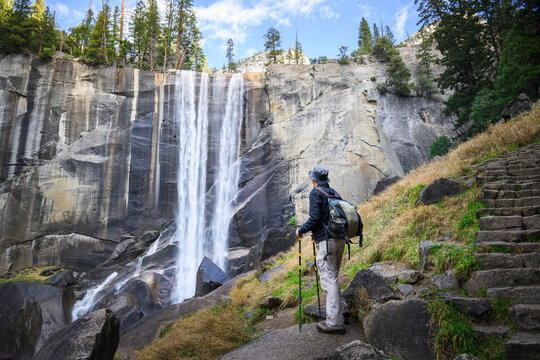 Man looking at Vernal Fall, hiking Mist Trail. Yosemite National Park. California. USA.