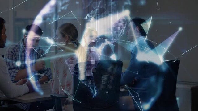 IT pro tapping tablet causing network lines linking team viewing rotating hologram in tech meeting