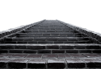 Wide staircase constructed from dark gray bricks leading upwards isolated on a transparent background