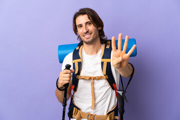 Young mountaineer man with a big backpack over isolated background happy and counting four with fingers