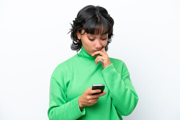 Young Argentinian woman isolated on white background thinking and sending a message