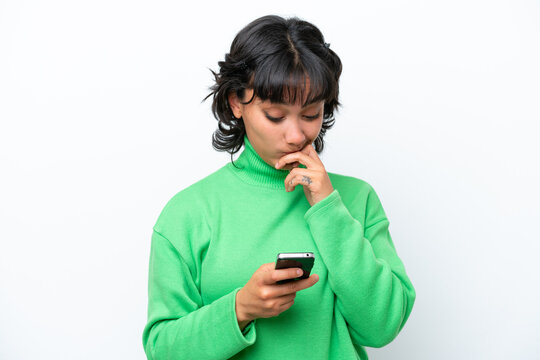 Young Argentinian woman isolated on white background thinking and sending a message