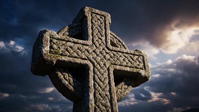 Stone celtic cross against dramatic cloudy sky symbolism