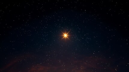Fototapeta premium A bright star shining in a dark night sky with many small stars.