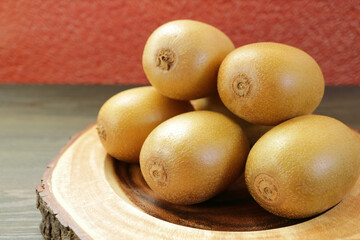 Pile of fresh ripe gold kiwifruits, an excellent source of vitamin C, dietary fiber, folate and antioxidants
