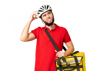 Young delivery man with thermal backpack over isolated chroma key background having doubts and with confuse face expression