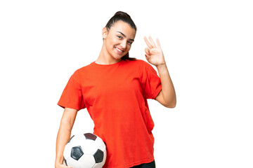 Young beauty woman over isolated chroma key background with soccer ball and making OK sign