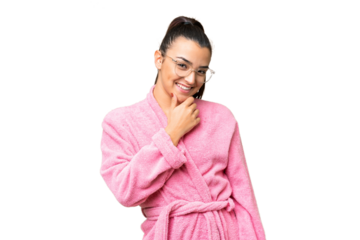 Young woman in a bathrobe over isolated chroma key background with glasses and smiling