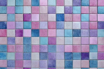 Fototapeta premium A colorful mosaic of small square tiles in shades of pink blue and purple
