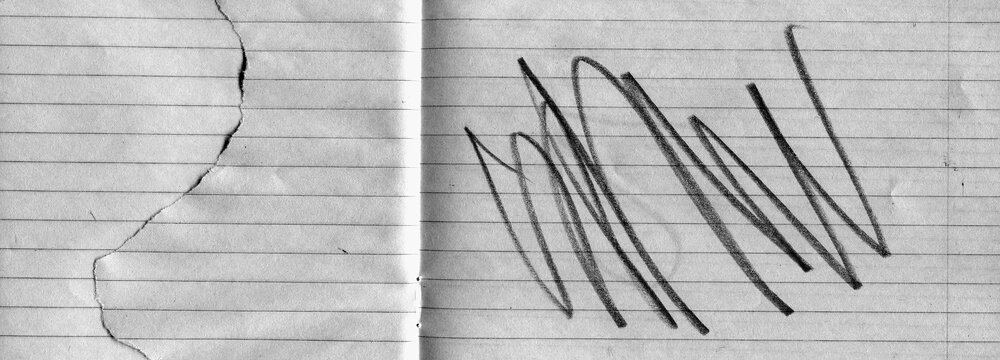 Lined notebook paper texture with fold crease, torn edge and black expressive pencil marks. Minimal yet emotional background combining stationery surface with abstract gesture and contrast