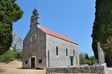 Ancient stone Church of Our Lady of Mount Carmel stands against a clear blue sky in Karmen near Orebic on the Peljesac peninsula