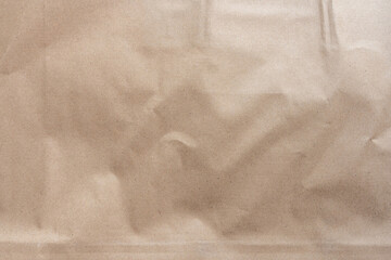Crumpled light brown craft paper texture with visible wrinkles and subtle grain detail