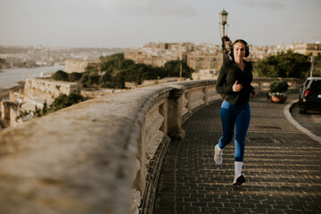 Woman jogging along the scenic streets of Malta during golden hour