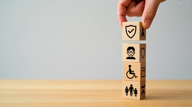 Hand stacks blocks with icons for security, disability, and family support, symbolizing comprehensive social welfare and future planning