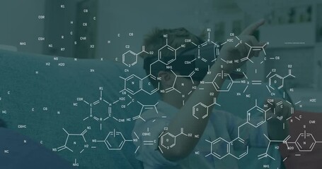 Animation of chemical equations over caucasian boy using vr headset - Powered by Adobe