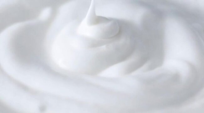 Smooth creamy white texture with soft peaks and gentle swirls, clean and minimal appearance, close-up macro view, rich and silky surface, suitable for skincare cream, lotion, skincare footage video 
