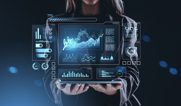 Businesswoman holding digital tablet with glowing stock charts a - Powered by Adobe