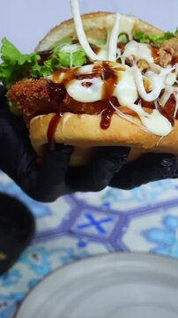 Adding Mayonnaise on Zinger Burger &ndash; Fast Food Preparation Close Up