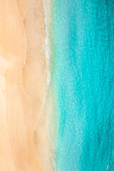 Pristine tropical Mediterranean beach aerial view with calm ocean waves white sand coastline top perspective relaxing summer vacation tropical island paradise serene nature landscape travel background