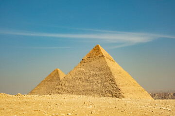 Exploring ancient pyramids at Giza in Egypt under a clear blue sky