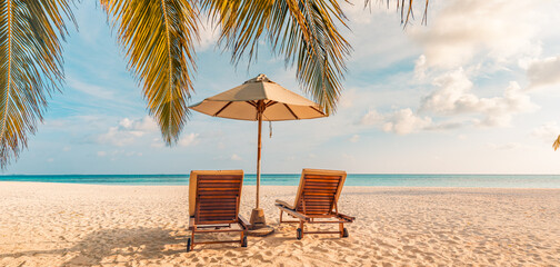 Romantic honeymoon beach scene with love couple resting on sun beds under umbrella tropical island ocean view serene summer vacation luxury resort travel background