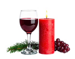 Glass of red wine next to a burning red candle,white background.