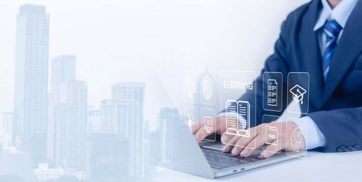 This image represents the concept of modern corporate e-learning. It features a businessman in a professional suit using a laptop, blended with a faded cityscape to symbolize global connectivity. - Powered by Adobe