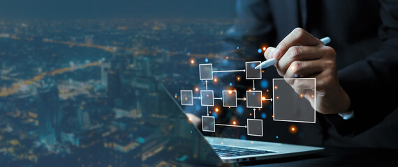 This image shows a person using a digital pen to design a virtual workflow on a laptop, with connected blocks and arrows symbolizing data flow, system architecture, and modern digital innovation.