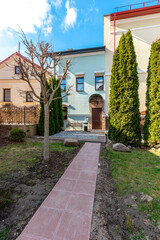 Cozy Residential Courtyard with Pathway and Evergreen Trees