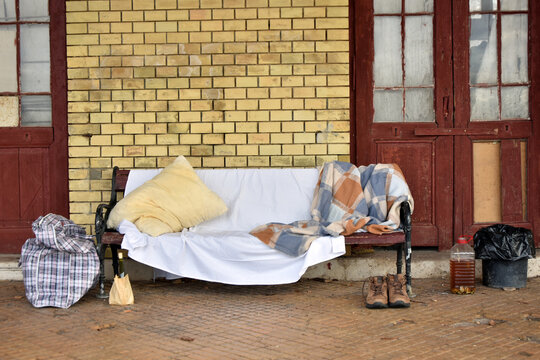 Homeless person stuff left on a street bench