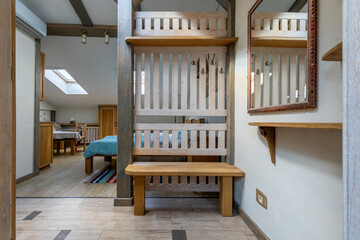 Rustic hallway interior with wooden bench and mirror