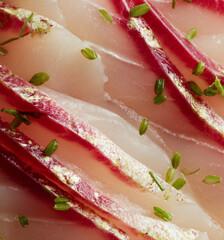 Close-up of sea bream sashimi slices, delicate texture, subtle marbling, glossy surface