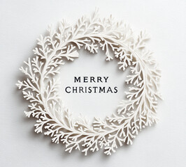 Merry Christmas wreath decoration with white branches and a simple greeting displayed on a light background