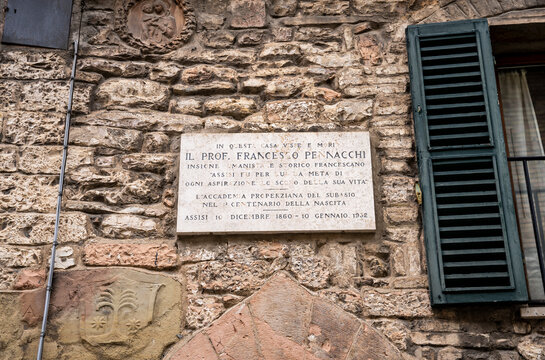Commemorative plaque on the house where scholar and historian Francesco Pennacchi once lived, in via Fontebella, medieval historic center of Assisi, Umbria, Italy