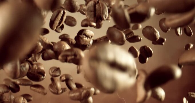 Fragrant coffee beans soar in the frame. Coffee beans shot on super slow motion camera 1000 fps.