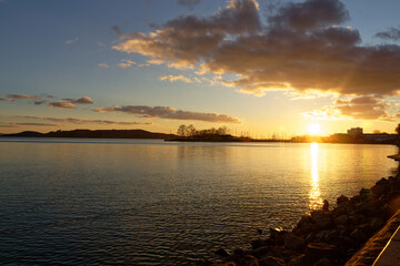 Sunset over Balaton in Hungary with calm water and distant hills