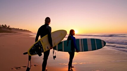 Couple surfing at golden sunset beach, holding surfboards, ocean waves, silhouette