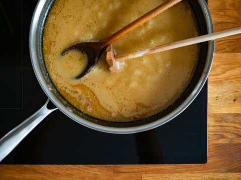 Gravy sauce in frying pan on electric stove. Top view
