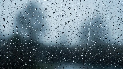 Obraz premium Raindrops on Glass Window with Blurred Background.