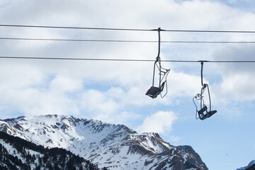 Two Empty Chairlifts Hanging Over Snowy Mountain Slope in Winter Ski Resort