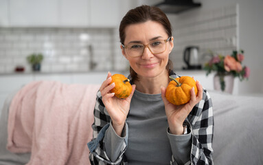 Girl In Glasses Holding Orange Small Pumpkins