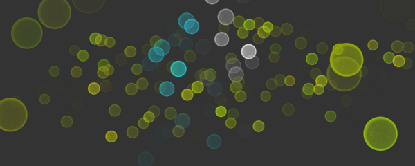 Colorful abstract bokeh circles with glowing light particles on dark background