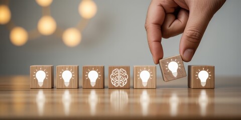 A hand carefully selects a wooden block with a lightbulb icon emphasizing the concept of innovative ideas and problem solving