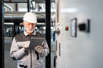 Senior engineer using tablet for plant maintenance check