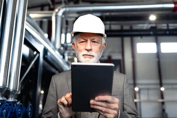 Fotobehang Ridders Senior engineer using tablet in industrial plant  © littlewolf1989