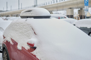 Snow calamity in city and removing snow from parked car