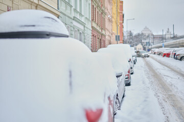 Snow calamity in city and removing snow from parked car