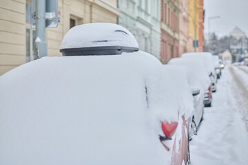 Snow calamity in city and removing snow from parked car