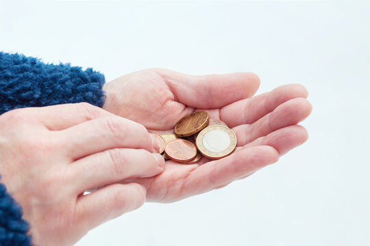 Euro coins in a woman's hands, selective focus.